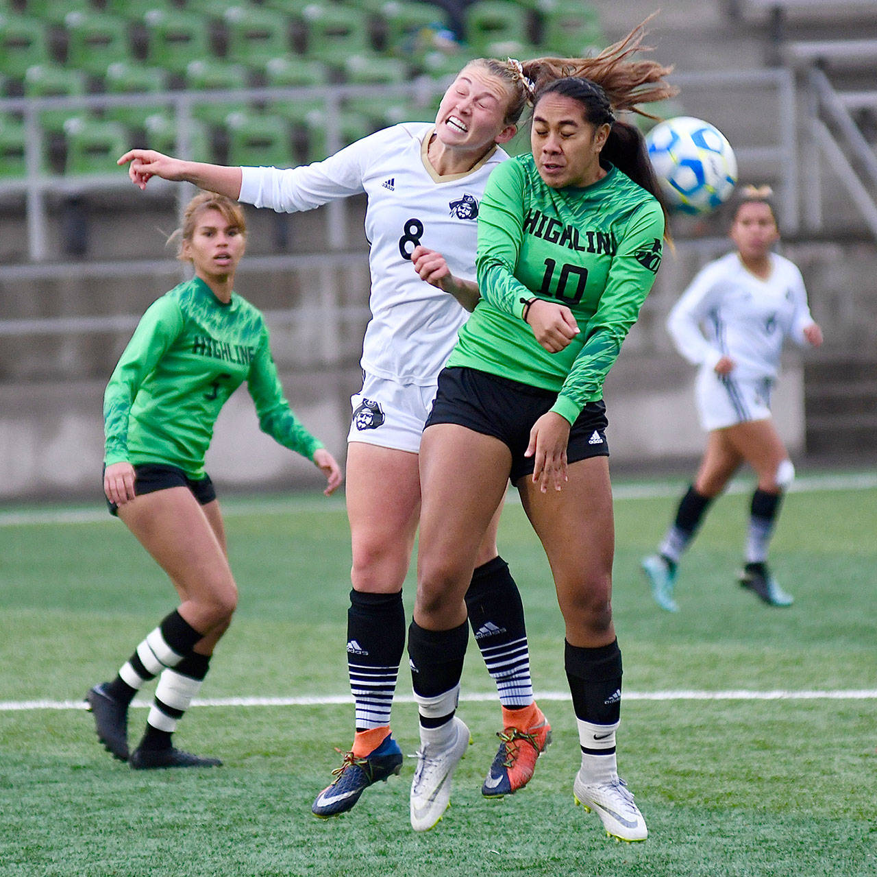 Peninsula’s Emilee Greve, left, goes up for a header with Highline’s kacy-Lyn Navarro in Friday’s NWAC semifinal in Tukwila. Peninsula won 1-0 and is playing the championship match today. (Jay Cline/for Peninsula Daily News)