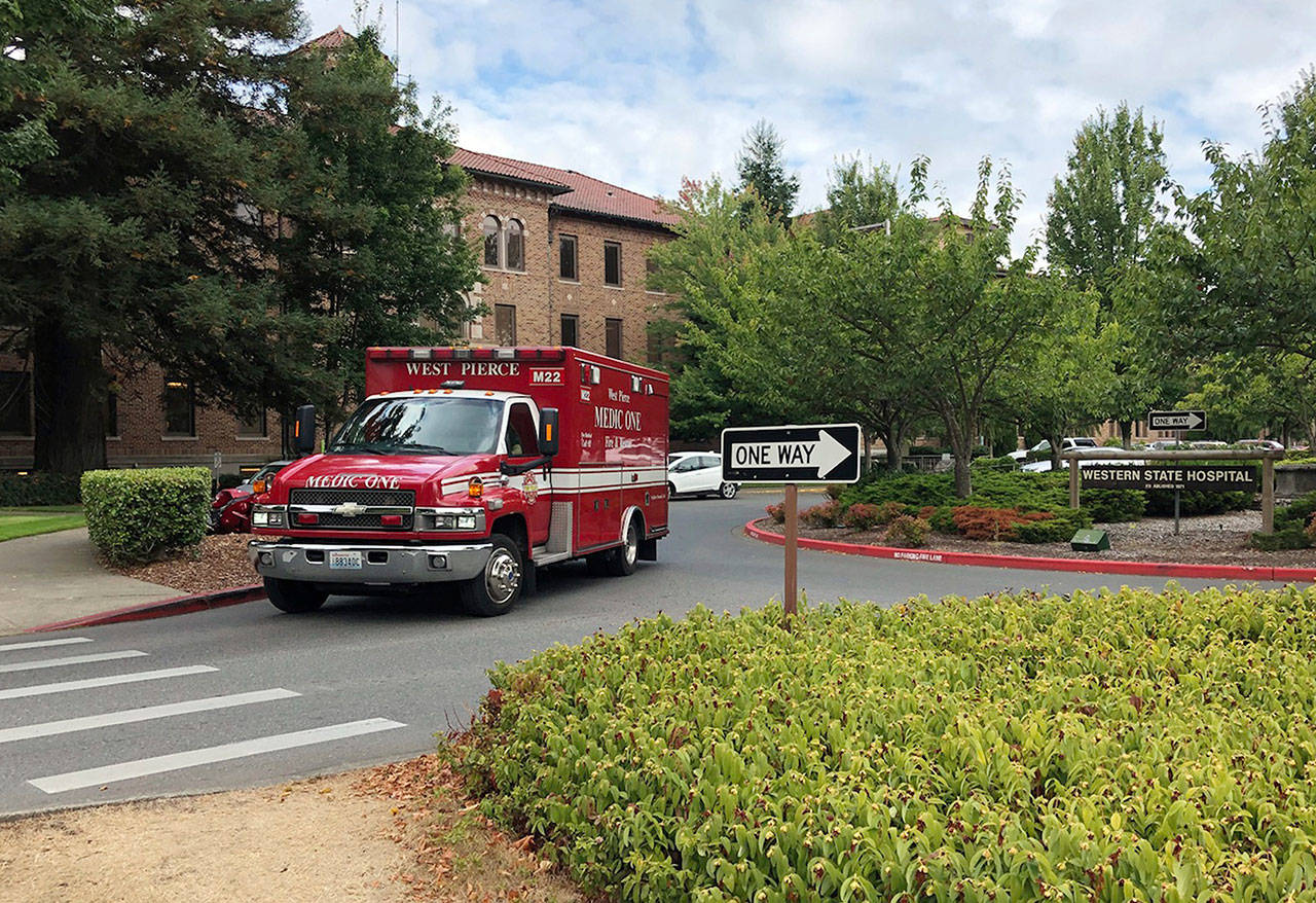 In this Aug. 30 file photo, an ambulance leaves Western State Hospital in Lakewood. (The Associated Press)