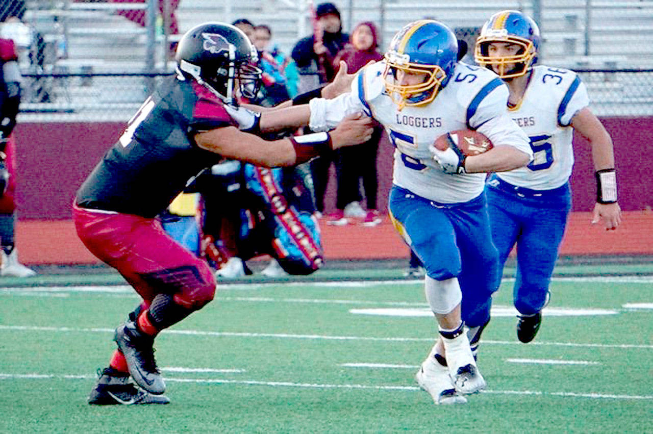 Crescent’s Noah Leonard runs for yardage against Lummi on Saturday. In on the play is Leonard’s teammate Eric Emery. Leonard finished with 302 yards rushing as the Loggers won 46-36 to qualify for their first state 1B football playoff berth since 1996.