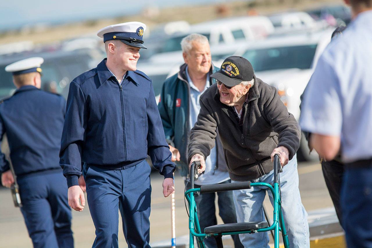 United States Coast Guard Seaman Sylvin Peaden talks with World War II veteran Bill Payne as he arrives to the Veterans Day ceremony at U.S. Coast Guard Air Station/Sector Field Office Port Angeles on Sunday. (Jesse Major/Peninsula Daily News)