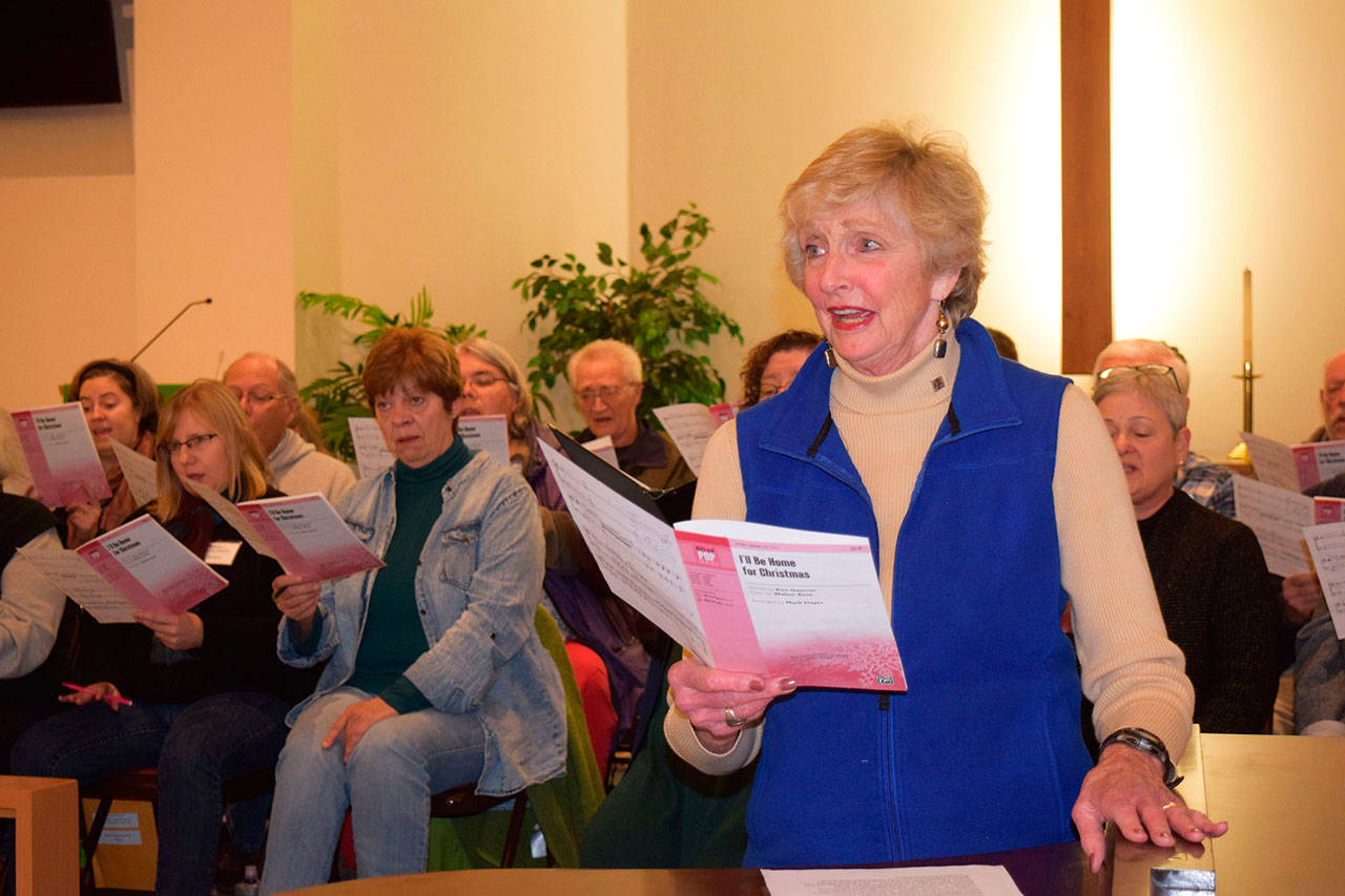 Carol Swarbrick, foreground, and the Peninsula Singers rehearse a variety of holiday songs for the upcoming fall concert Carols and Carol set for Saturday and Sunday at Trinity United Methodist Church, 100 S. Blake Ave. (Erin Hawkins/Olympic Peninsula News Group)