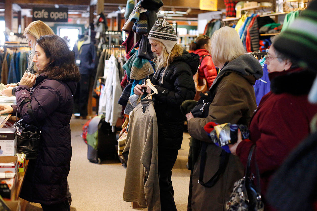 In this Nov. 29, 2014, file photo shoppers form a long line at checkout during Small Business Saturday at the Arcadian Shop in Lenox, Mass. (Stephanie Zollshan/The Berkshire Eagle via AP)