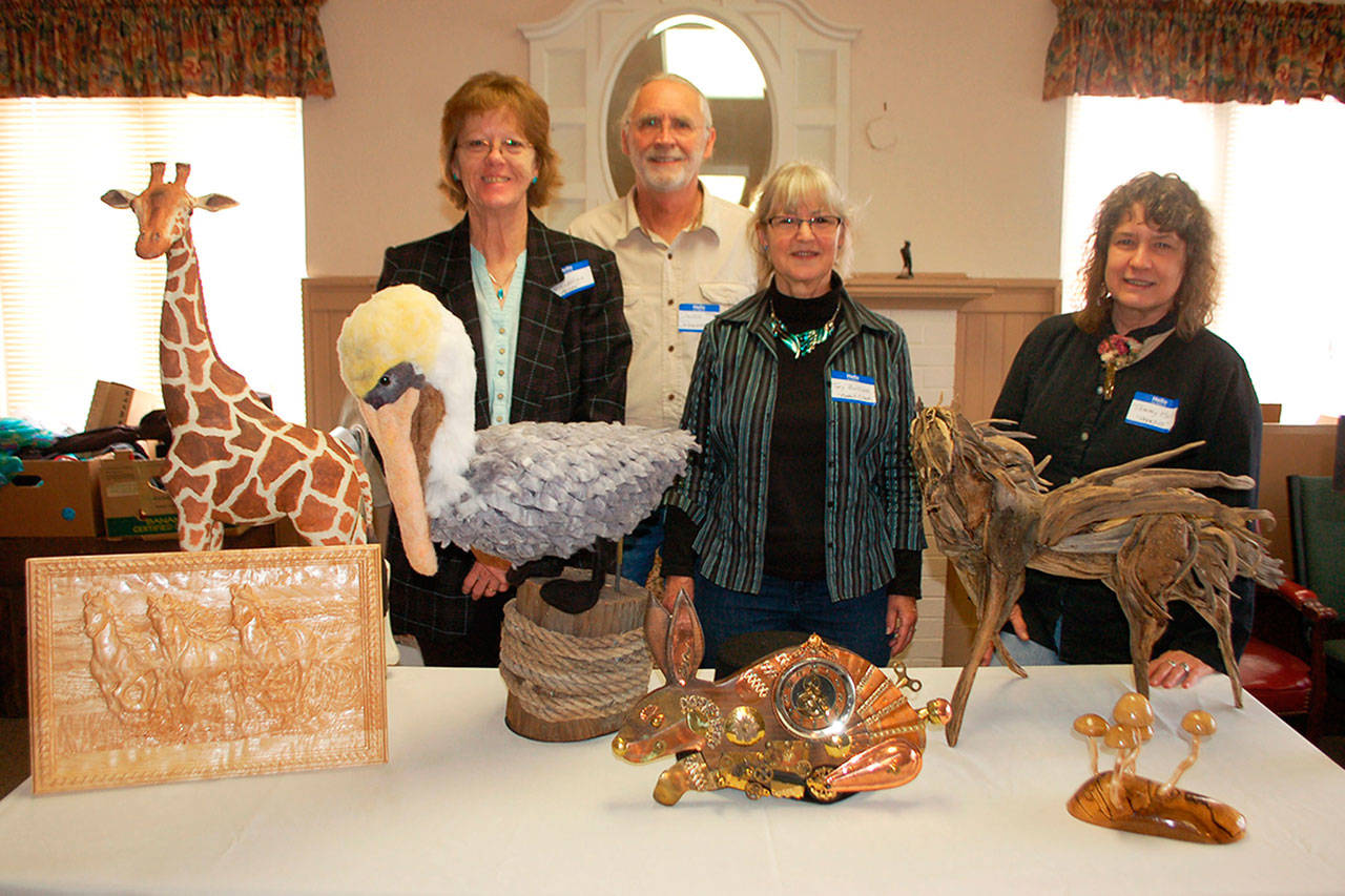 Olympic Theatre Arts sets the stage for Heart for the Arts a fundraiser that promotes a variety of artists in the Sequim community. A few of the live auction contributing artists, from left, are Terri Biondolino with Hanka pelican sculpture of felt fiber; David Johannessohn; Toy Buillon, with her and her husband Tims (not pictured) piece Rabbit Clock made from wood and random items; and Tammy Hall with her driftwood sculpture Pegasus. (Erin Hawkins/Olympic Peninsula News Group)