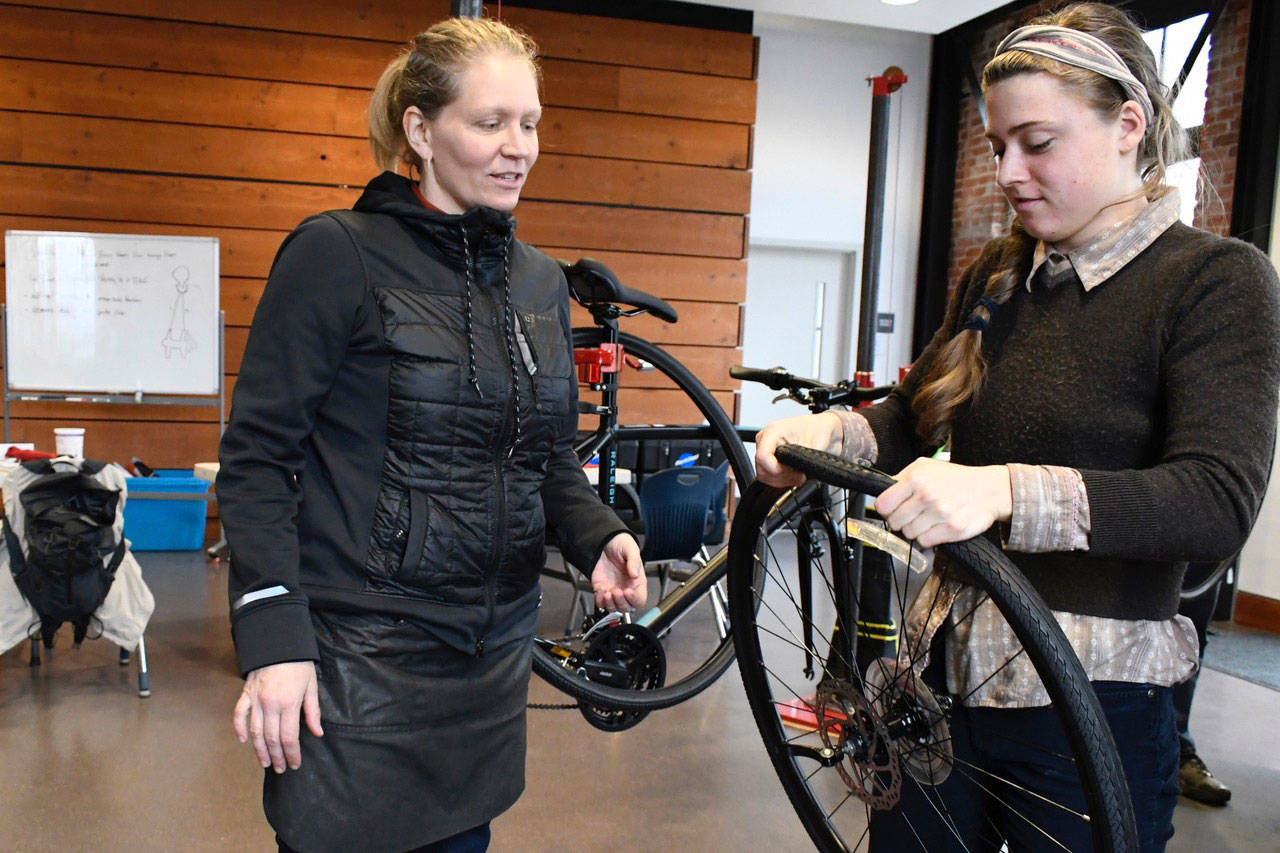 Instructor Tori Bortman, left, of Gracie’s Wrench in Portland, Ore., helps Port Townsend student Tedi Beck during a bike mechanics class through the Port Townsend Cycle School. Beck said she “would love to become a bike mechanic.” Beck learned that bikes are “very custom and the more you can understand how to build a bike, the more you can build it to your own preferences. I find that really cool.” (Jeannie McMacken/Peninsula Daily News)