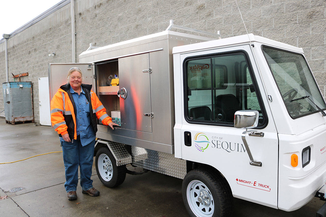 City of Sequim Public Works maintenance worker Cindy Budd stands by the city’s new Might-E-Truck, an electric vehicle that helps the city reduce fuel costs and emissions.