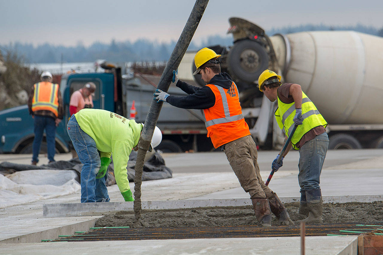 Crews pour concrete at the Port of Port Angeles’ new washdown facility on North Cedar Street on Tuesday. (Jesse Major/Peninsula Daily News)