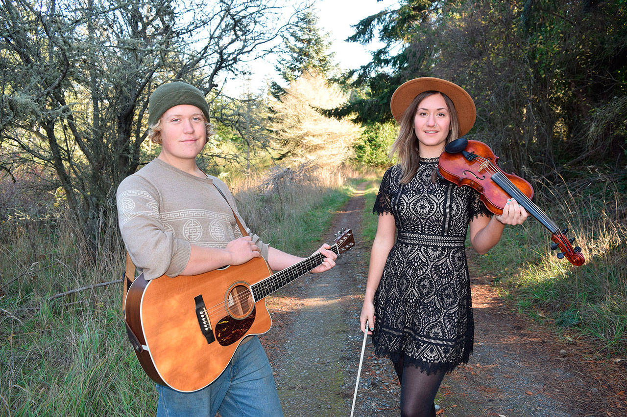 Will Jevne, left, and Chandra Johnson grew up playing the fiddle together in the Sequim and Port Angeles areas.