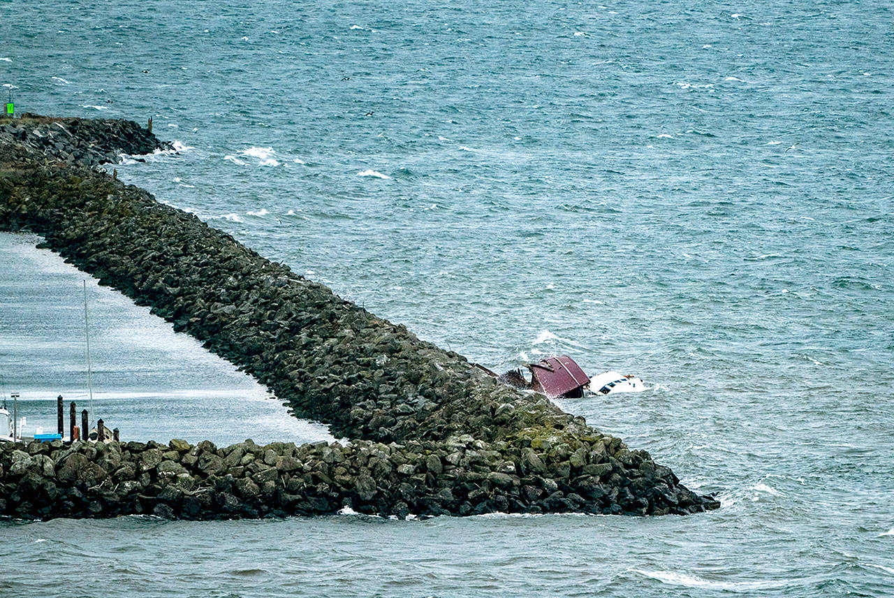 This boat broke free from its anchor in Port Townsend Bay and smashed into the Port of Port Townsend’s breakwater. (Steve Mullensky/for Peninsula Daily News)