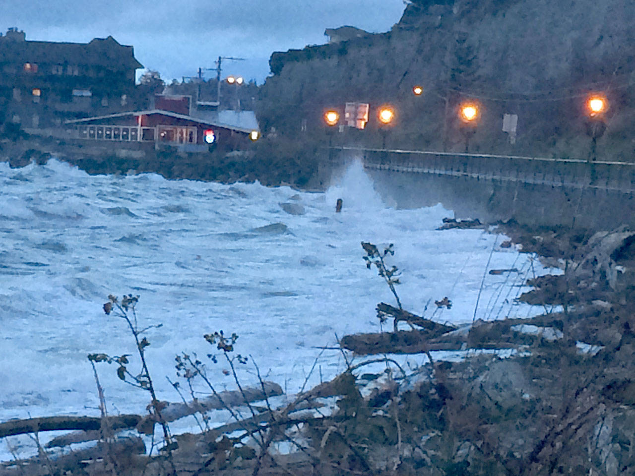 Waves crash against the breakwater along Water Street near the ferry landing in Port Townsend early Monday. (Andrew Swanson)