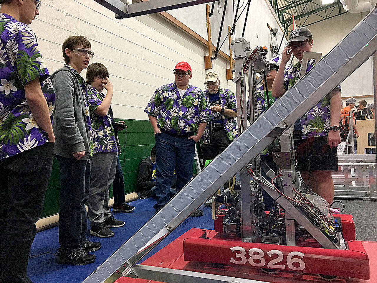 Sequim Robotics Federation team members gather for a weigh-in of their robot last year in Yakima. This year, the team hosts a fundraiser Saturday at Sequim High School with a luau and auctions.