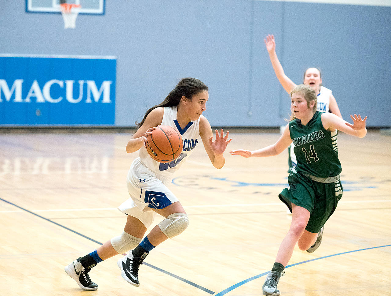 Steve Mullensky/for Peninsula Daily News Chimacums Mia McNair, left, drives while defended by Charles Wrights Grace Hanley during a district playoff game last season.