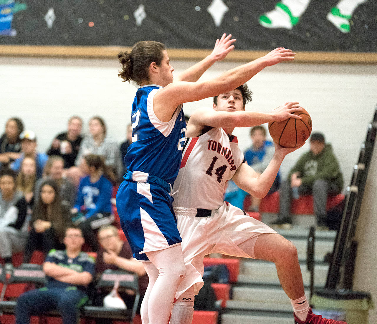 Steve Mullensky/for Peninsula Daily News Chimacum’s Cole Dotson defends Port Townsend’s Noa Montoya along the base line during a rivalry game last season.