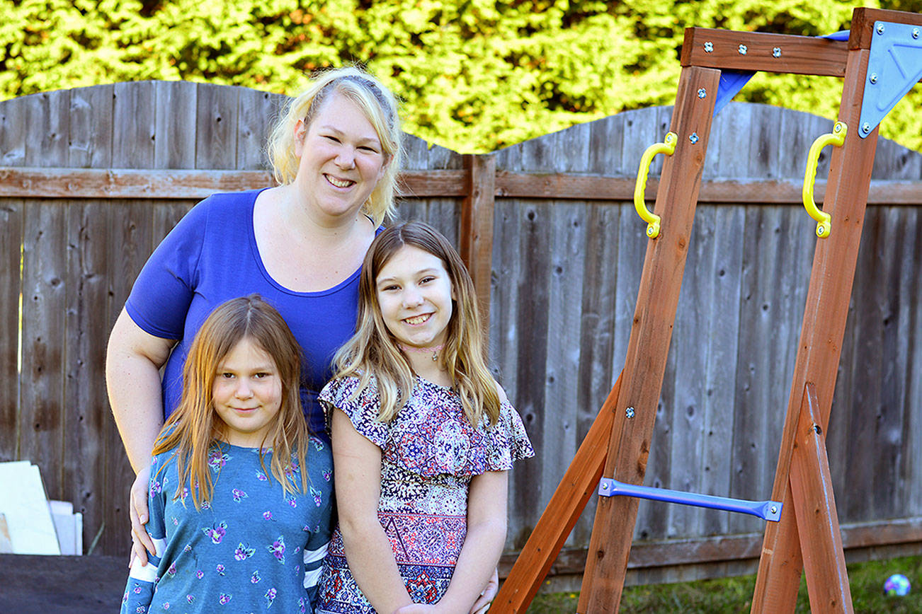 Alexis Haire lives in the Port Angeles home she built for herself and her daughters Maddie, 7, left, and Lily, 11. (Diane Urbani de la Paz/for Peninsula Daily News)