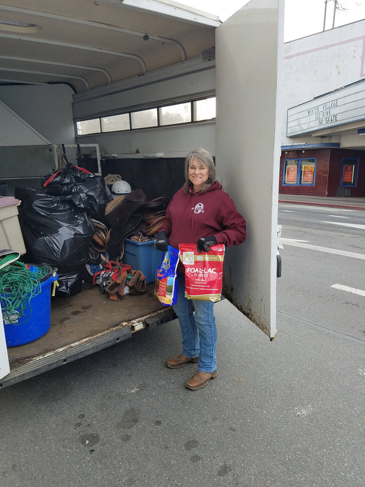 In answer to a call from the Port Angeles Elks Club for horse items to donate to California’s fire victims, Valerie Jackson of the Olympic Peninsula Equine Network unloads items they were going to use for OPEN’s own fundraiser because “we know what it’s like to be in need.” (Diane Royall)