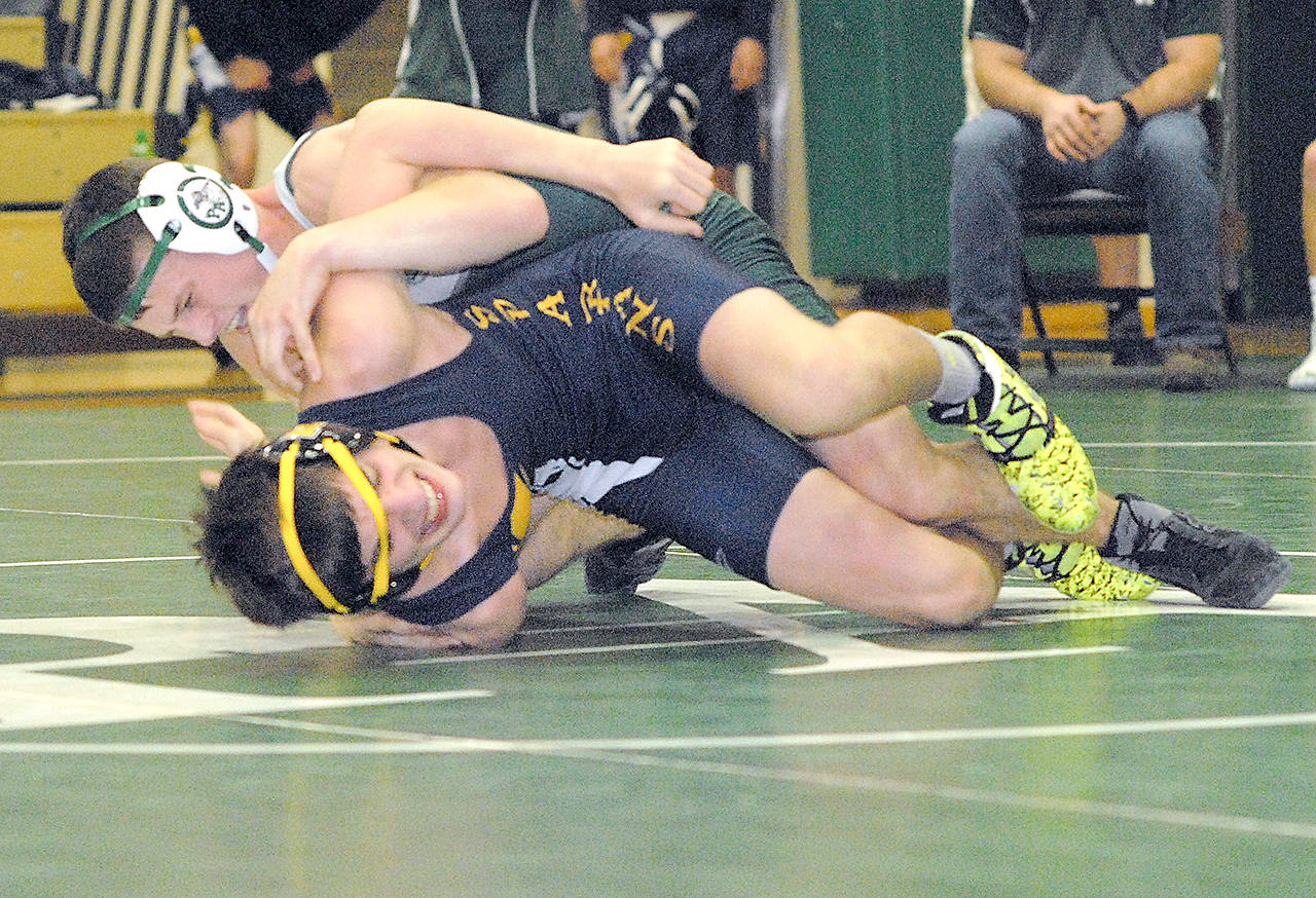 Keith Thorpe/Peninsula Daily News Port Angeles’ Adam Borde (top) and Forks’ Colton Duncan wrestle a 132-pound match during the Wrestle-Rama Jamboree last week at Port Angeles.