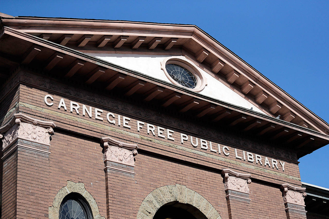 In this photo taken Oct. 10 the Carnegie name remains on what was the first major branch of the Seattle public library system, built with funds from philanthropist Andrew Carnegie. In service until 1963, the building now houses a variety of private enterprises. (Elaine Thompson/The Associated Press)