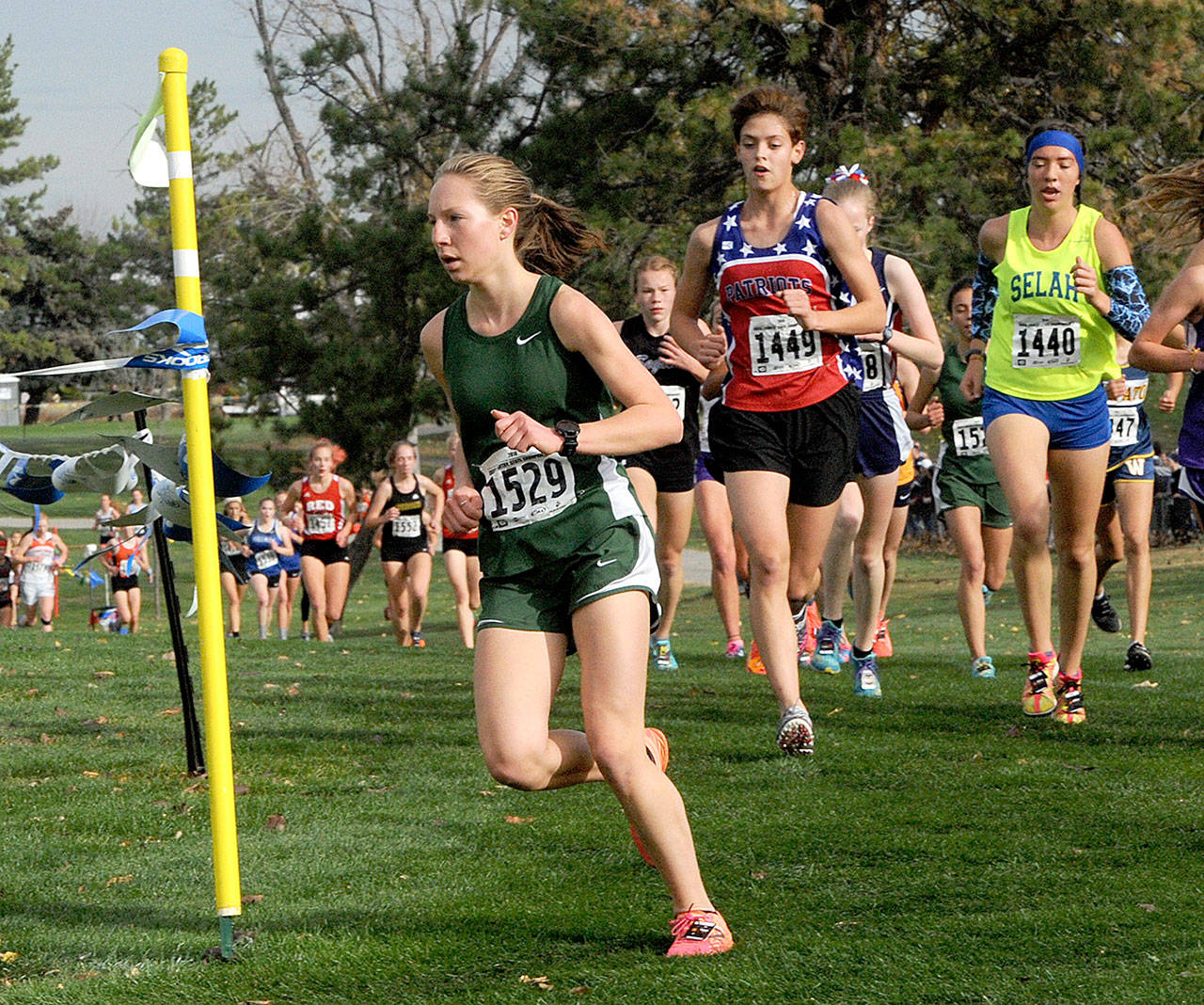 Lauren Larson leads the pack at the state 2A girls cross-country meet in Pasco in October. Larson ended up finishing fourth. (Lonnie Archibald/for Peninsula Daily News)
