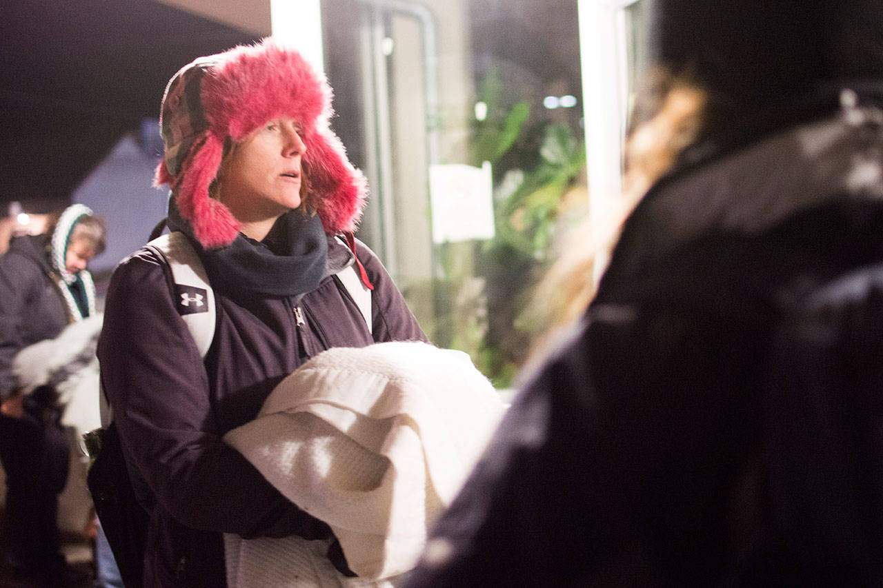 Amy Miller talks with people outside Salvation Army early Thursday morning. (Jesse Major/Peninsula Daily News)