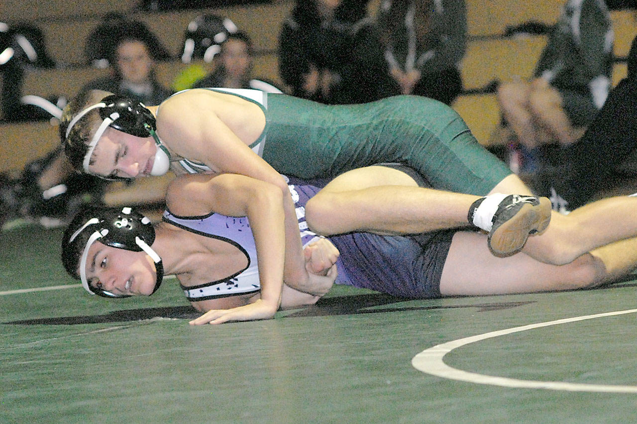 Keith Thorpe/Peninsula Daily News Port Angeles Daniel Basden, top, takes on North Kitsaps Carson Monette in the 126 lb., bout on Thursday at Port Angeles High Schoo. Basden won the matchup with a pin.