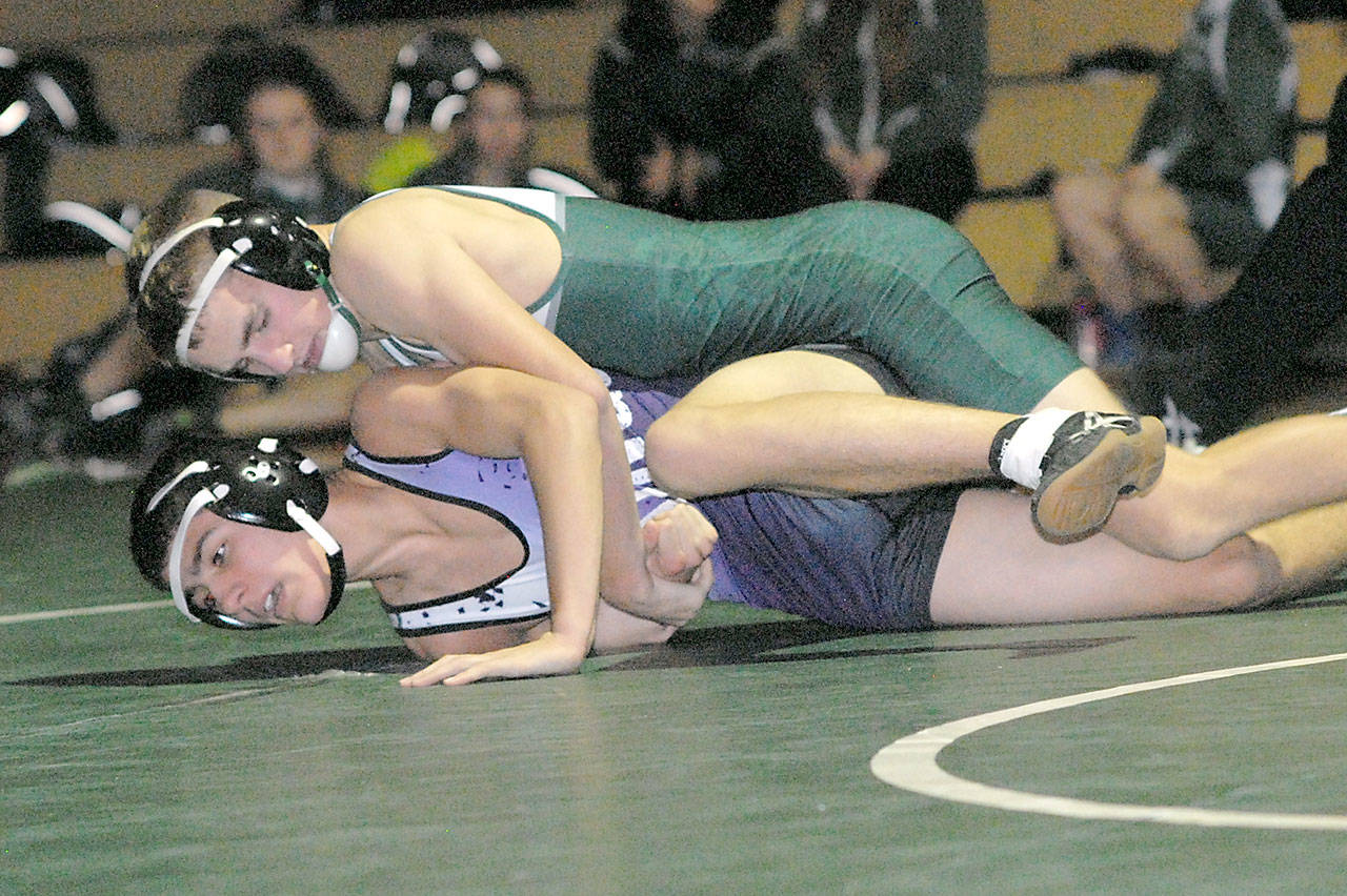 Keith Thorpe/Peninsula Daily News Port Angeles’ Daniel Basden, top, takes on North Kitsap’s Carson Monette in the 126 lb., bout on Thursday at Port Angeles High Schoo. Basden won the matchup with a pin.