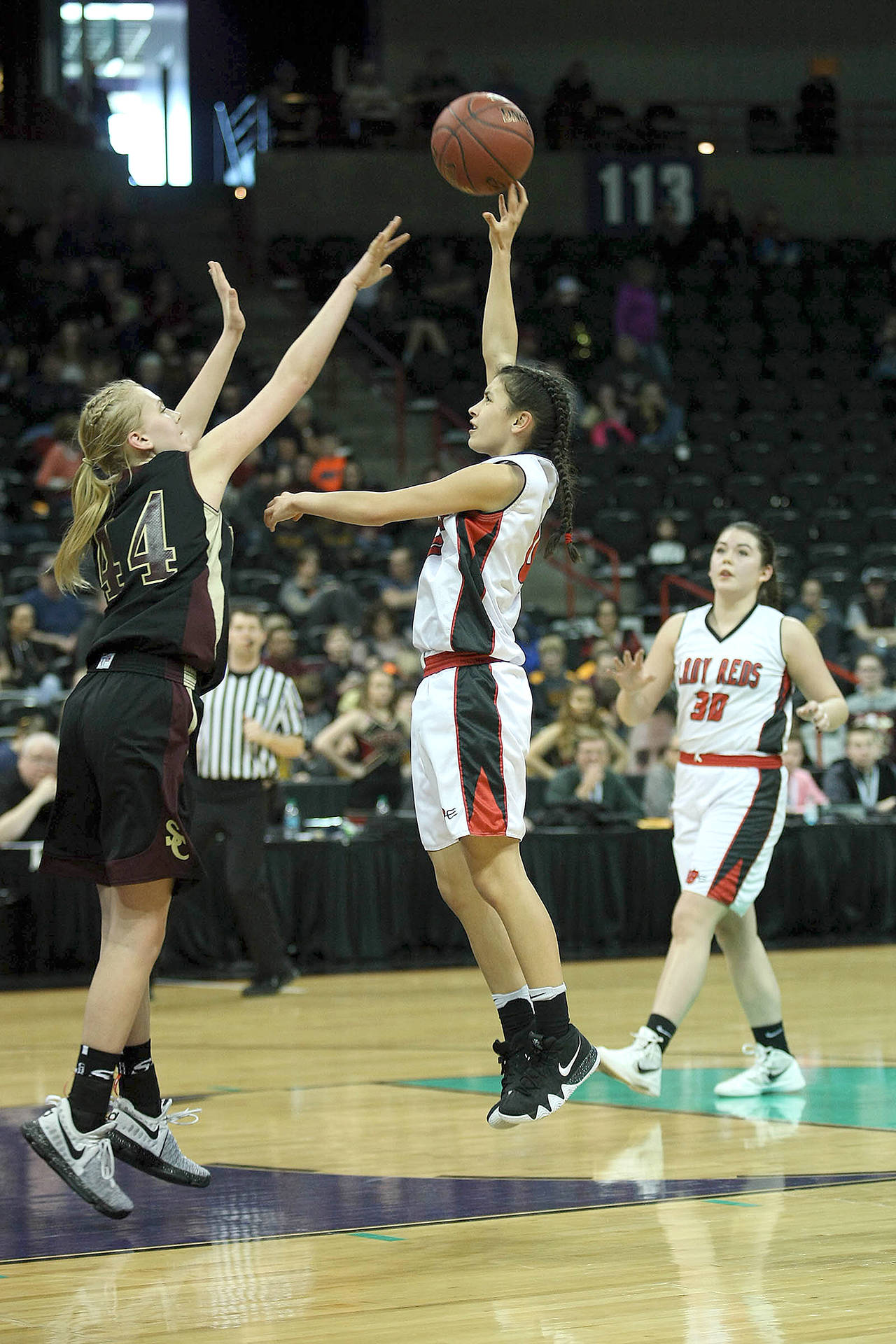 David Willoughby Neah Bay’s Laila Greene shoots over a Sunnyside Christian defender during the Class 1B Girls Basketball State Tournament last season at Spokane Arena.