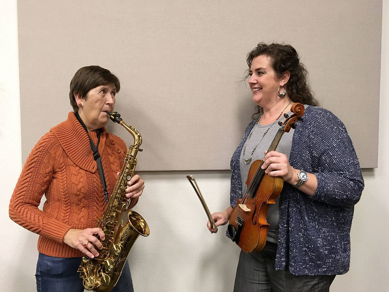 Debbi Soderstrom, left, and Beth Pratt, presidents of the boards of the Sequim City Band and the Sequim Community Orchestra, gear up for the Sunday’s holiday concert featuring both groups.