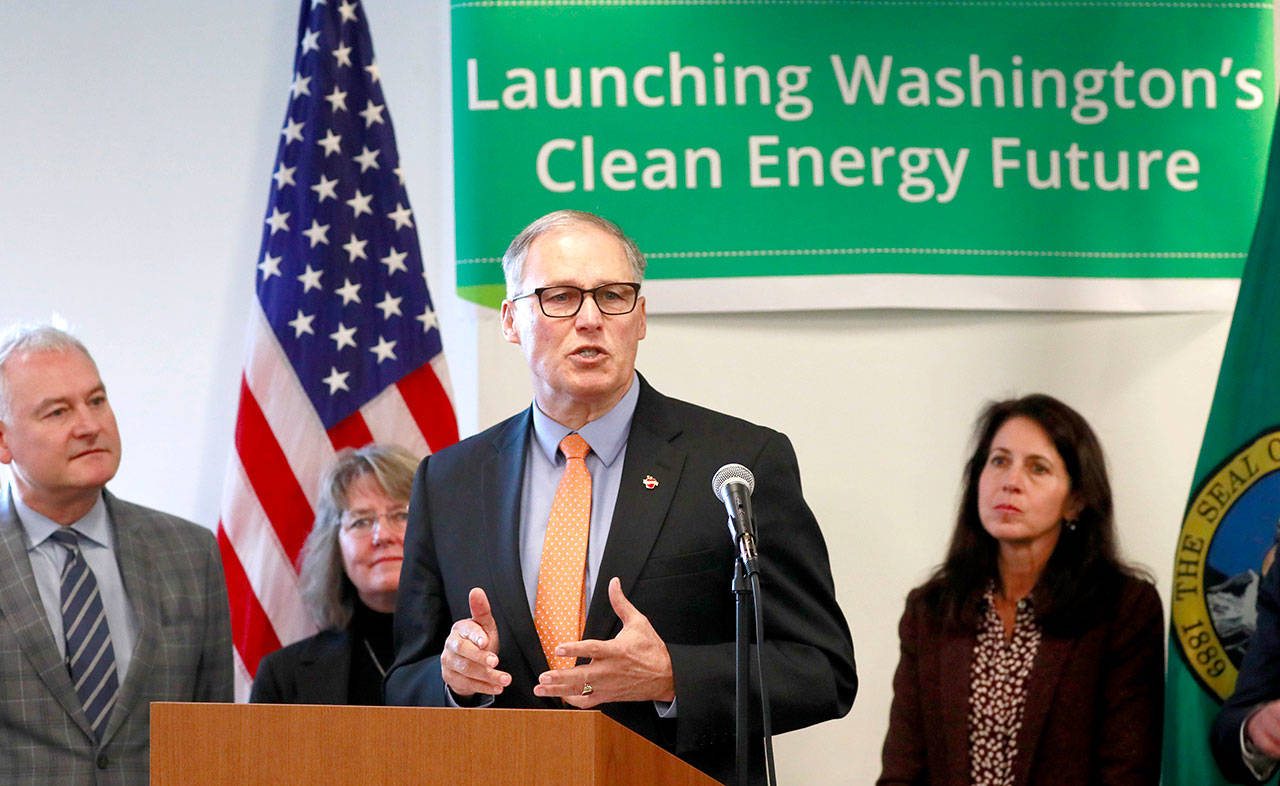 Gov. Jay Inslee speaks about tackling climate change during a press conference at Pacific Tower in Seattle on Monday. (Erika Schultz/The Seattle Times via AP)