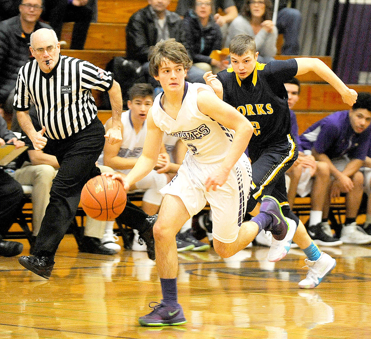 Michael Dashiell/Olympic Peninsula News Group Sequims Joey Oliver dribbles away from Forks Seth Johnson during the Wolves 72-70 win over the Spartans on Monday in Sequim.