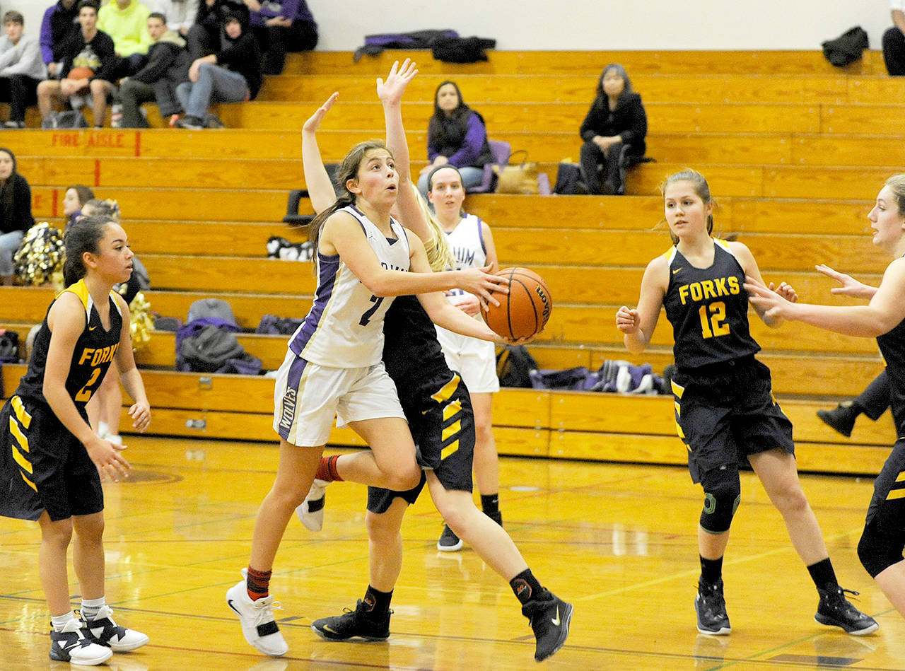Michael Dashiell/Olympic Peninsula News Group Sequim’s Jessica Dietzman drives and prepares to shoot inside against Forks during the Wolves’ 81-25 win Monday.