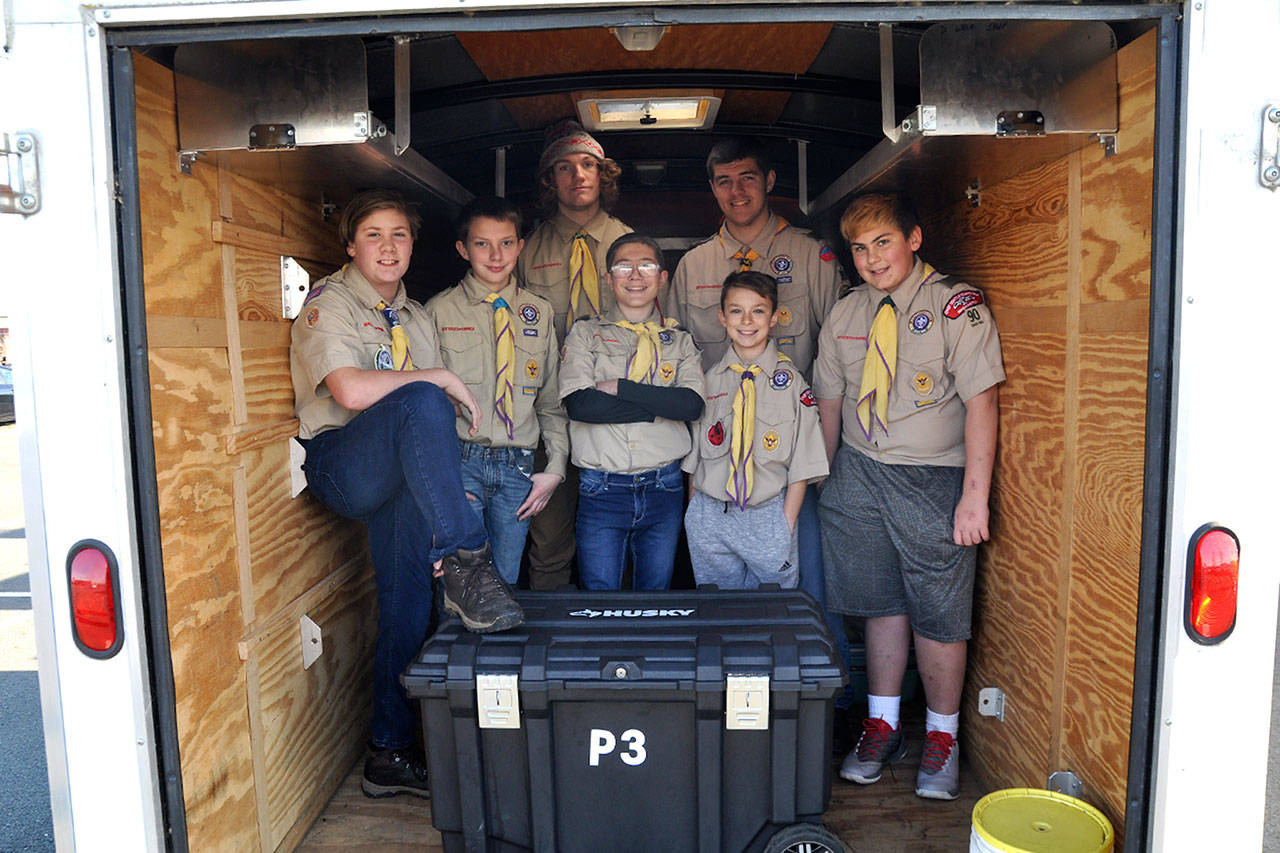 Boy Scouts with Troop 90 in Sequim stand inside the trailer that a thief or thieves broke into sometime last month and took about $900 in camping equipment. (Matthew Nash/Olympic Peninsula News Group)