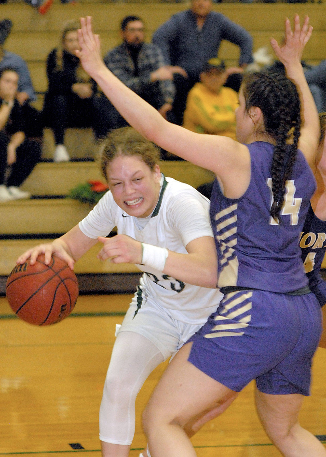 Keith Thorpe/Peninsula Daily News Port Angeles’ Madison Cooke, left, slips around the defense of North Kitsap’s Noelani Barreith on Tuesday night at Port Angeles High School.