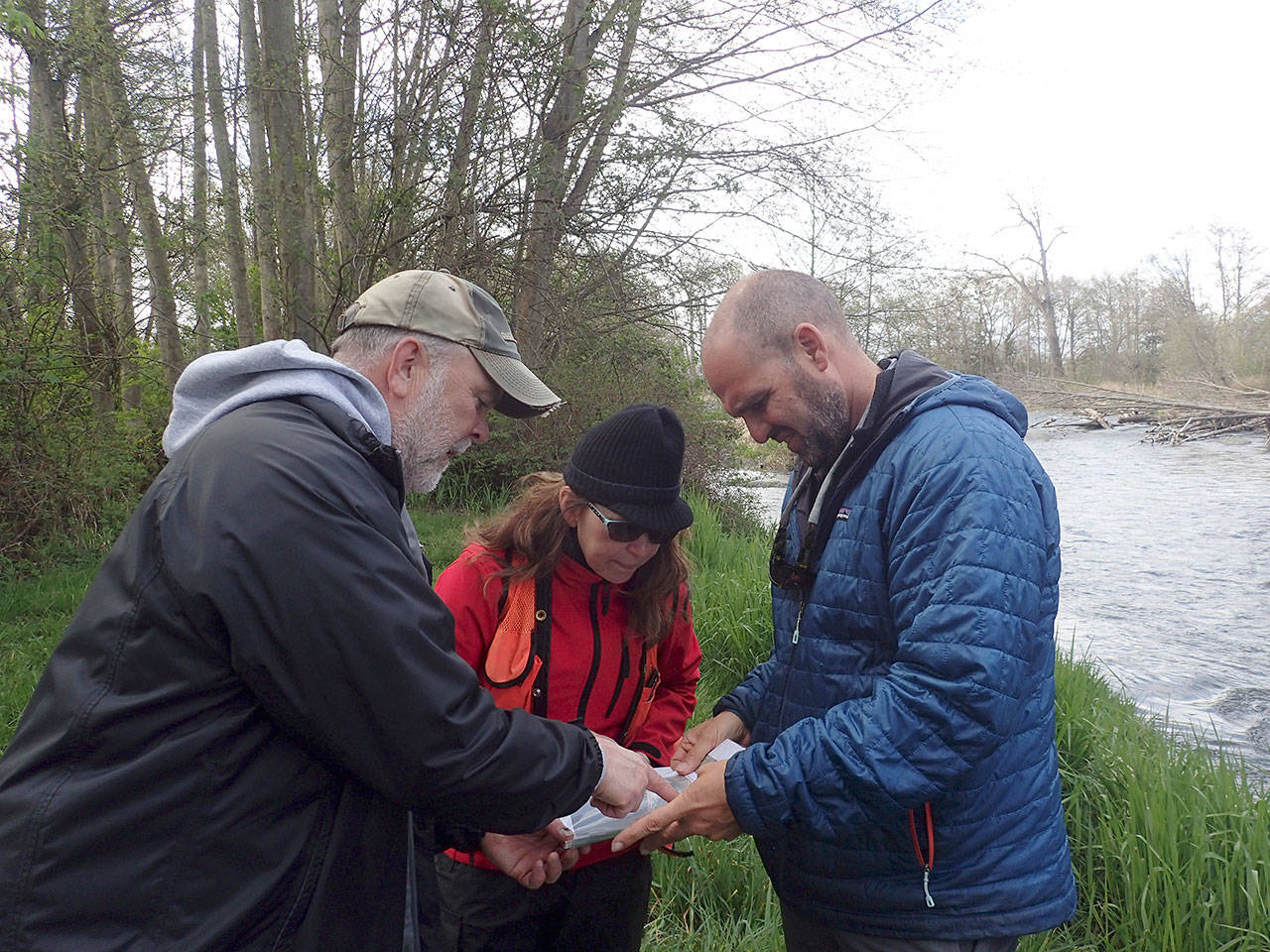From left, Matt Heins, Dungeness Duck Club manager, talks with Marnie Tyler of the Salmon Recovery Funding Board Review Panel and Kevin Long, North Olympic Salmon Coalition Project Manager, at a proposed restoration site at the Dungeness Duck Club. (North Olympic Lead Entity for Salmon)