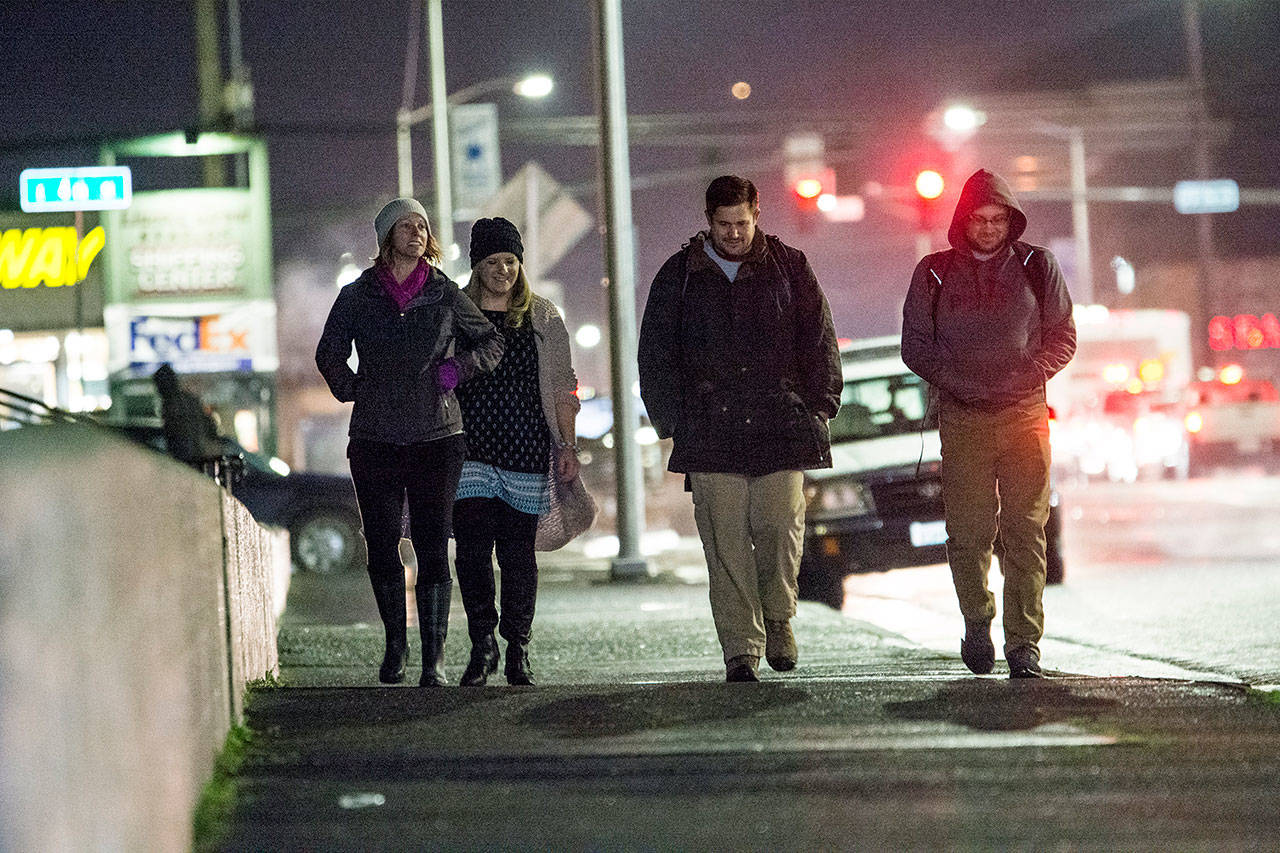 Amy Miller, Shenna Younger, Port Angeles City Manager Nathan West and City Council member Mike French walk toward Veterans Memorial Park on Thursday evening. (Jesse Major/Peninsula Daily News)