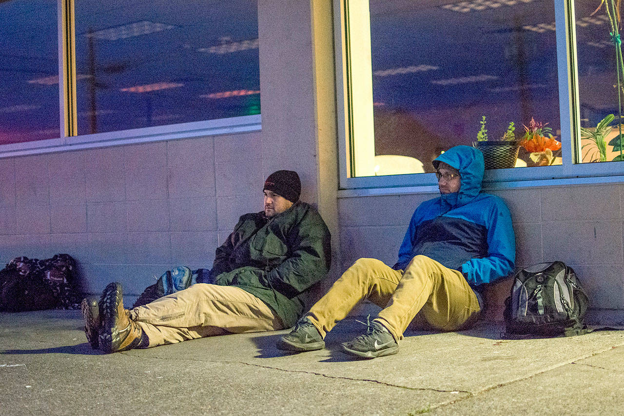 Port Angeles City Manager Nathan West and council member Mike French sit outside the Salvation Army on Friday morning. (Jesse Major/Peninsula Daily News)