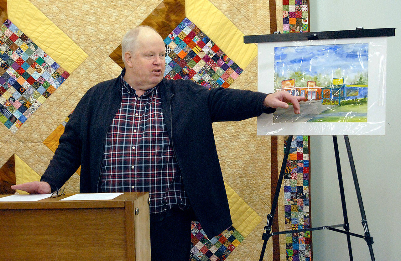 Doc Robinson, executive director of Serenity House of Clallam County, on Saturday points to an artist’s rendering of the Bridges Grill and a nearby laundromat on Eighth Street in Port Angeles that are under consideration for purchase by his agency to provide services for homeless young adults. (Keith Thorpe/Peninsula Daily News)
