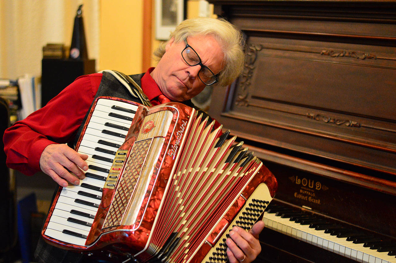 “Although Paul is a fabulous keyboard player, my favorite tunes are when he plays his accordion,” said Carla Main, singer with the Holiday Hi-Jinx Band. Hi-Jinx 2018 arrives at the Quimper Unitarian Universalist Fellowship hall in Port Townsend this Sunday. (Diane Urbani de la Paz/for Peninsula Daily News)