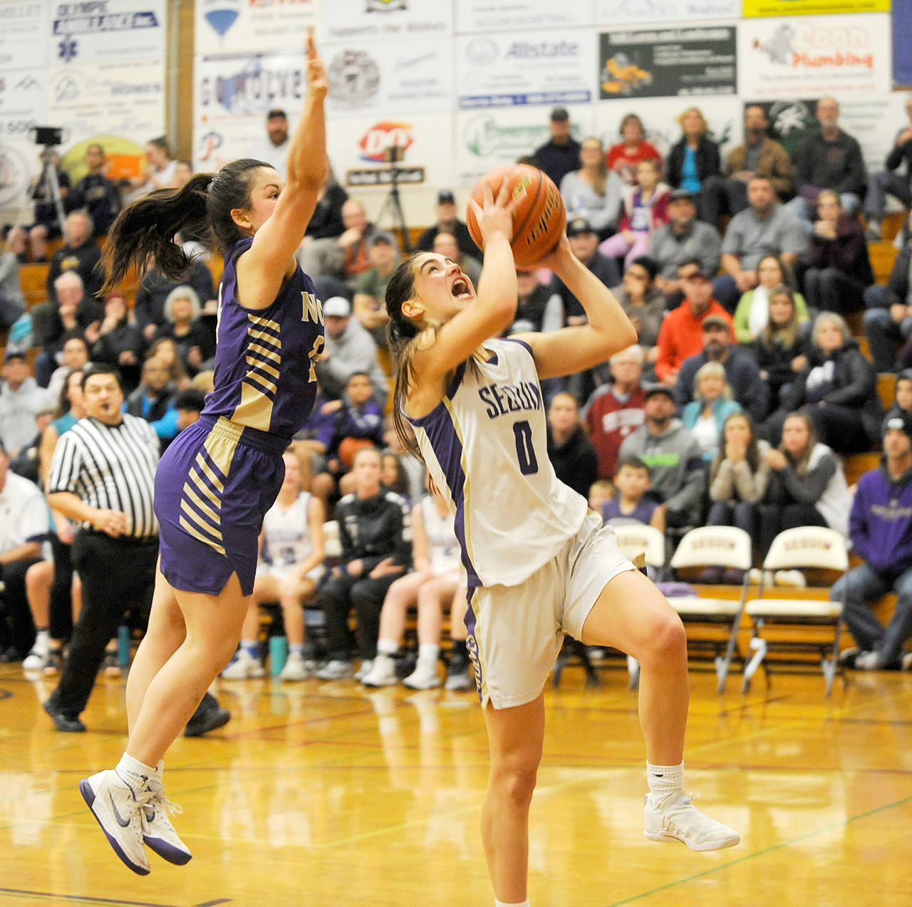Michael Dashiell/Olympic Peninsula News Group Sequim’s Hope Glasser, right, drives past North Kitsap’s Noelani Barreith in the second half of the Wolves’ 61-53 home loss to the Vikings.