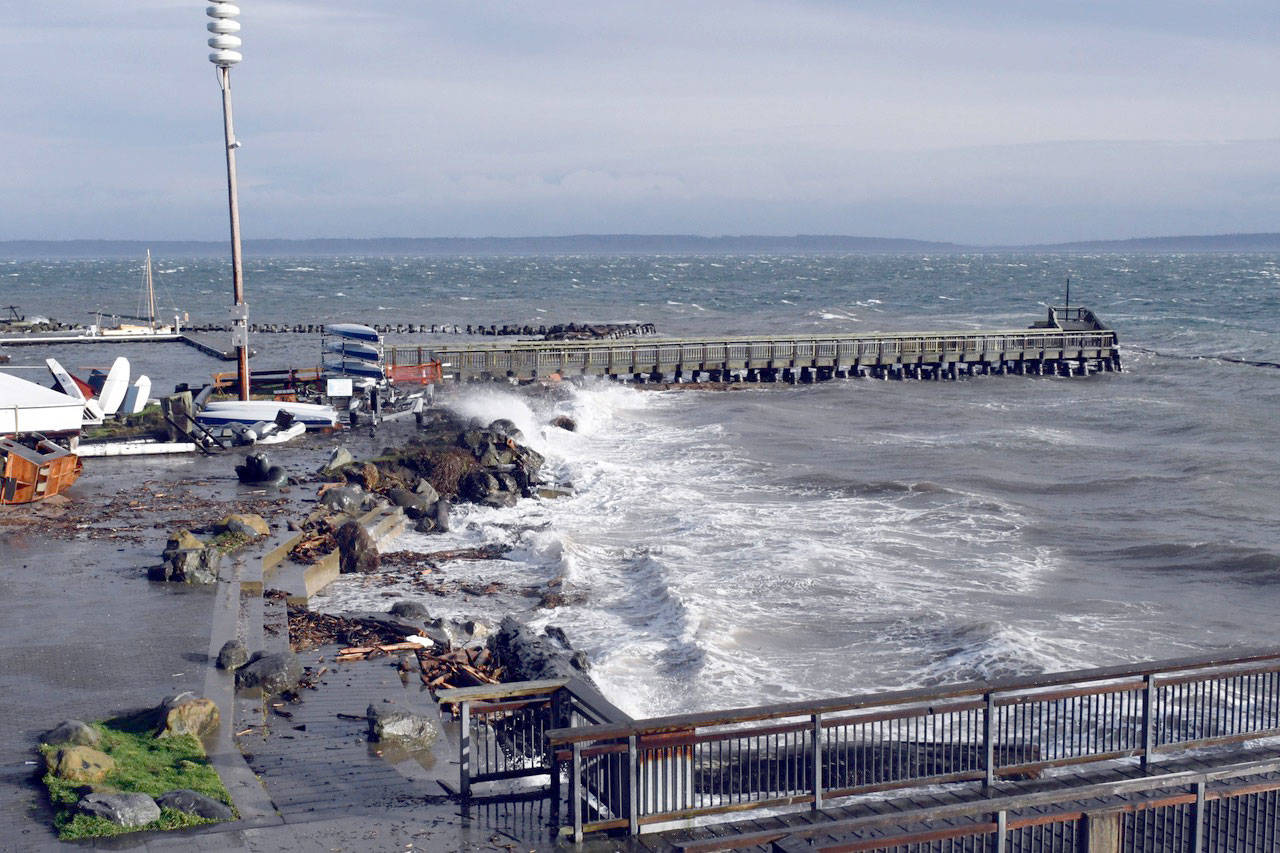 Port Townsend’s north breakwater was almost underwater and the south breakwater was battered by wind, waves and a high tide Thursday during the height of the storm. The Northwest Maritime Center’s beach disappeared under the surf, its rock and log seating almost completely gone, and debris scattered up onto the patio. (Jeannie McMacken/Peninsula Daily News)