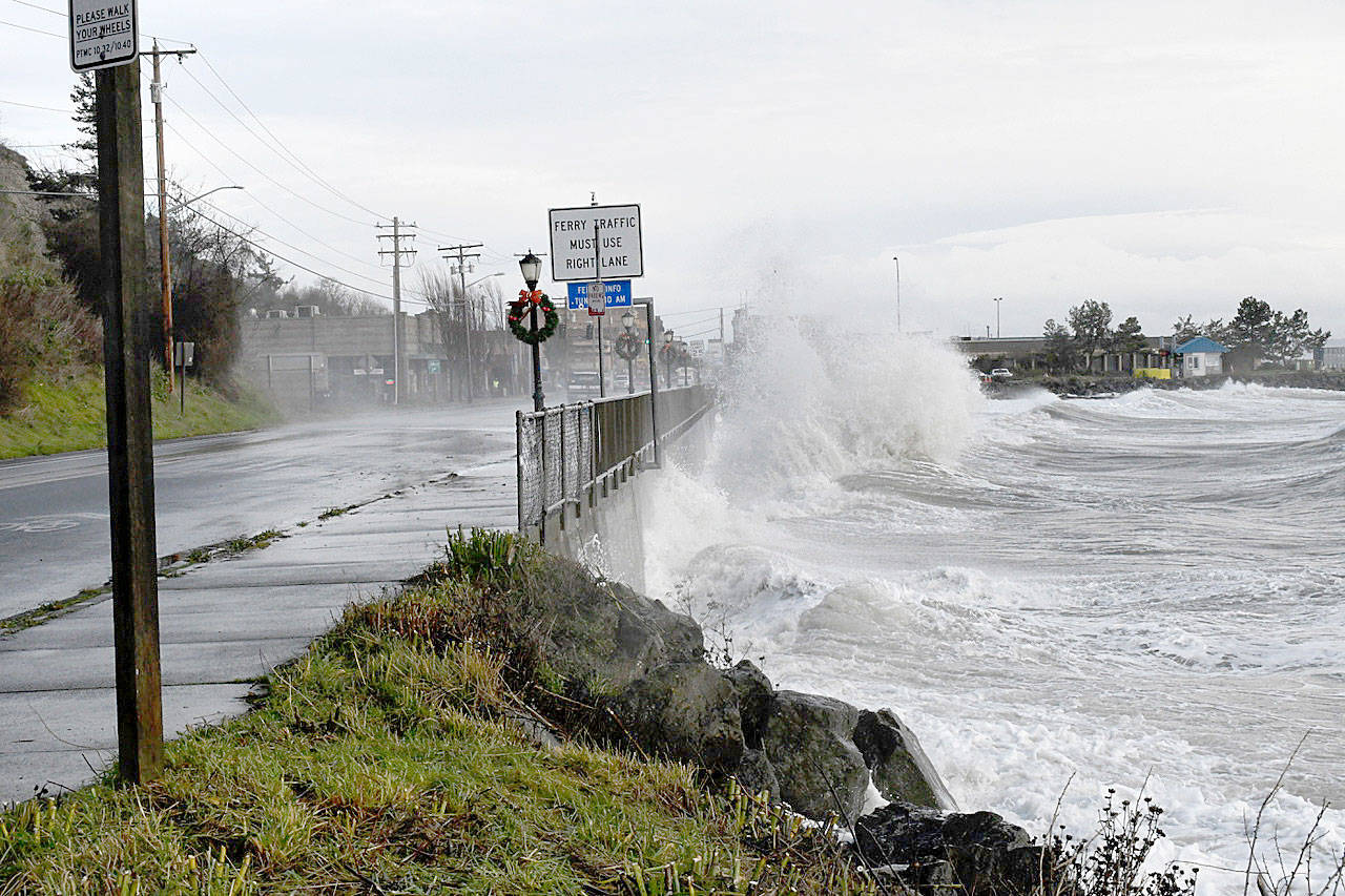 Storm-driven waves battered the sea wall and washed over Sims Way by the ferry terminal Thursday in Port Townsend (Jeannie McMacken/Peninsula Daily News)