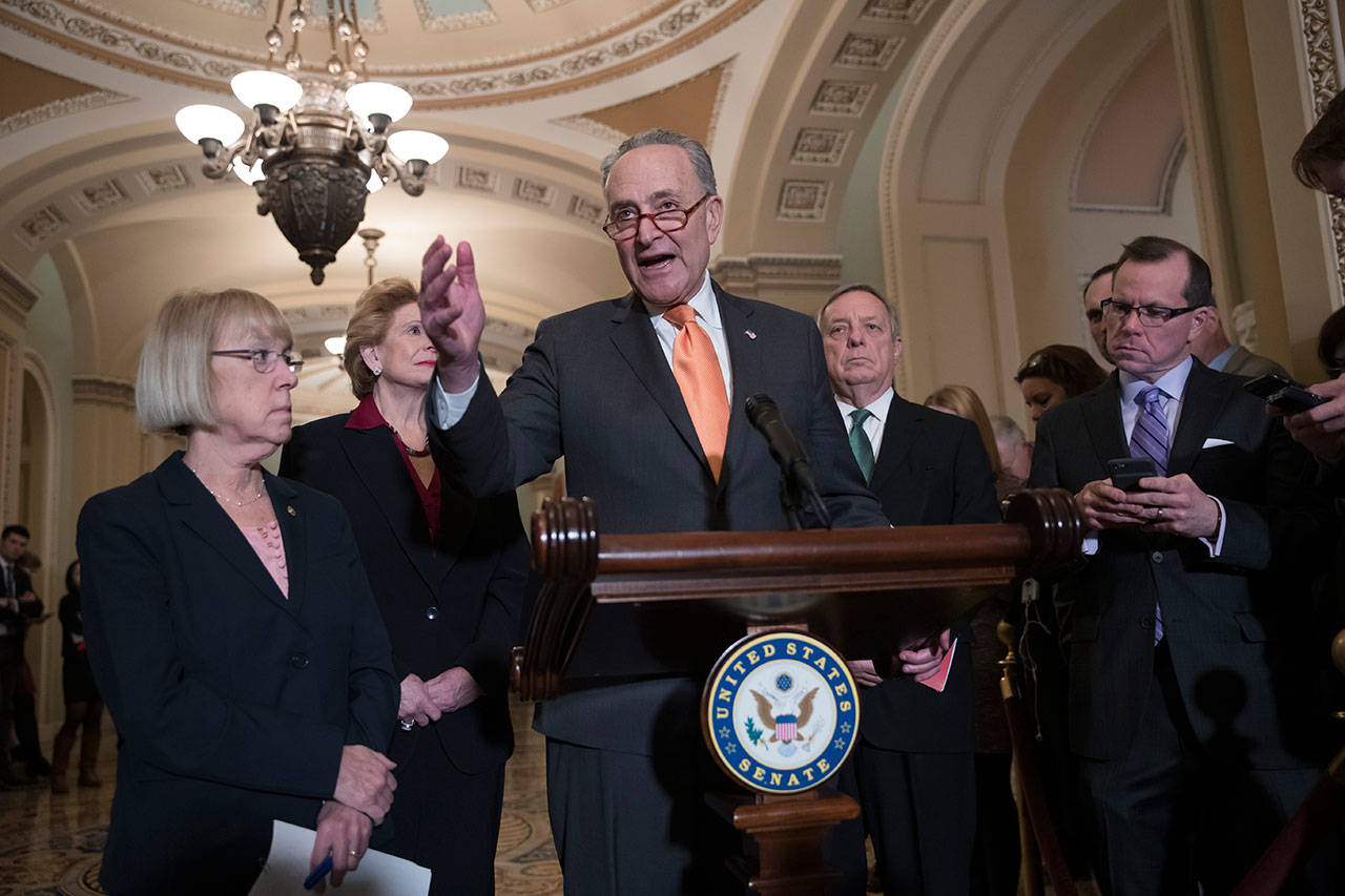 Senate Minority Leader Chuck Schumer, D-N.Y., talks to reporters about the possibility of a partial government shutdown at the Capitol in Washington. Surrounding him, from left, are Sen. Patty Murray, D-Wash., Sen. Debbie Stabenow, D-Mich., and Sen. Dick Durbin, D-Ill., the assistant Democratic leader. (J. Scott Applewhite/The Associated Press)