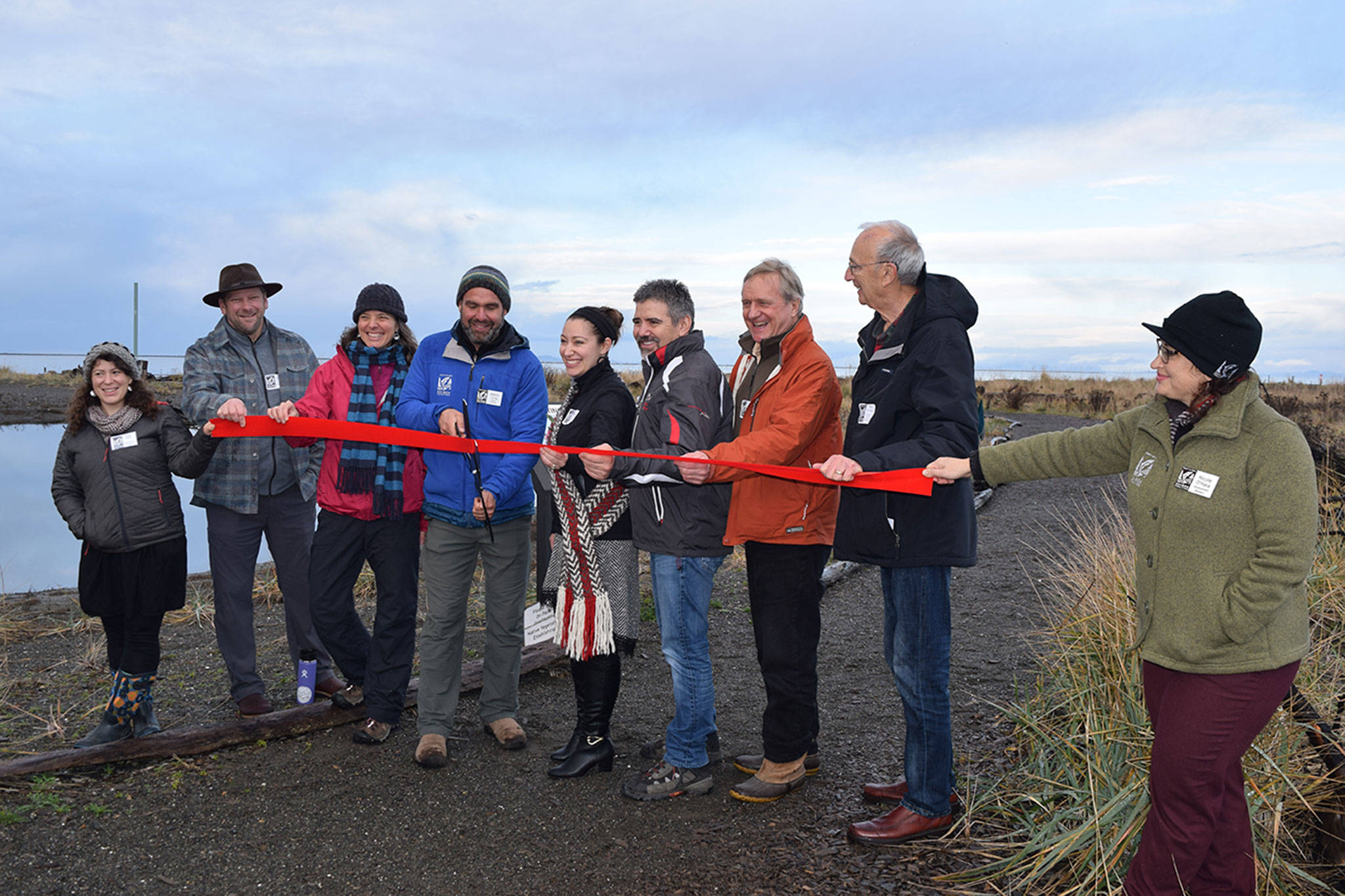 The North Olympic Salmon Coalition (NOSC ) celebrated a ribbon cutting for its 3 Crabs nearshore and estuarine restoration project at the public access point off 3 Crabs Road. From left are Sarah Albert, NOSC administrative assistant; state Rep. Mike Chapman; Rebecca Benjamin, NOSC executive director; Kevin Long, NOSC project manager; Loni Grinnell-Greninger, Jamestown S’Klallam Tribe; Kurt Grinnell, Jamestown S’klallam Tribe; state Rep. Steve Tharinger; Phil Rockefeller, Washington State Recreation & Conservation Office; and Nicole O’Hara, NOSC development manager. (Erin Hawkins/Olympic Peninsula News Group)