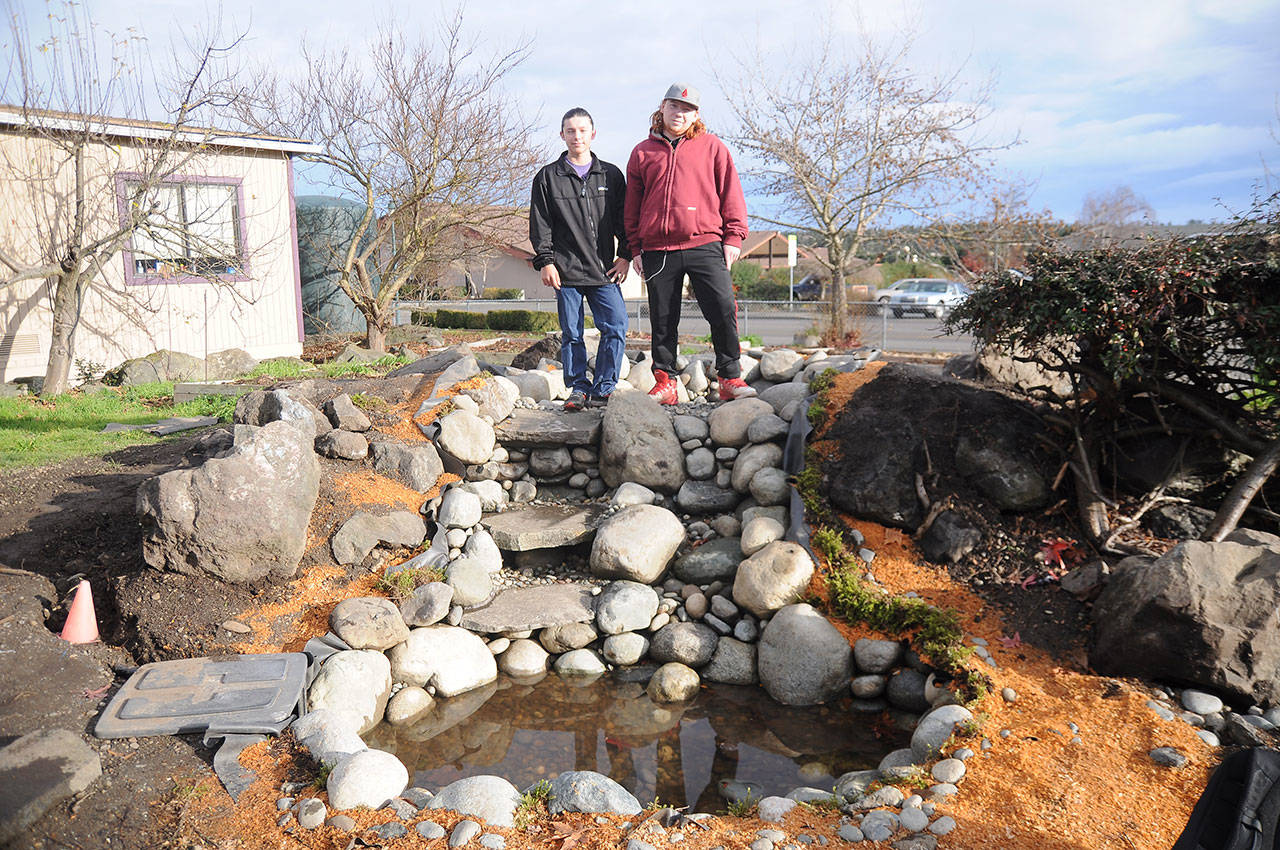 Tristin Holbert, left, and Chance Sare, both freshmen at Sequim High School, helped spearhead a class project to build a pond on the school campus. (Michael Dashiell /Olympic Peninsula News Group)