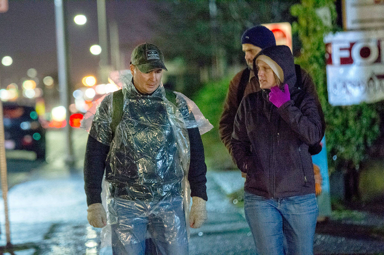 Clallam County Prosecuting Attorney Mark Nichols, left, talks with Amy Miller Thursday evening. Nichols and Clallam County Commiissioner Mark Ozias stayed overnight at Serenity House of Clallam County’s night-by-night shelter. (Jesse Major/Peninsula Daily News)