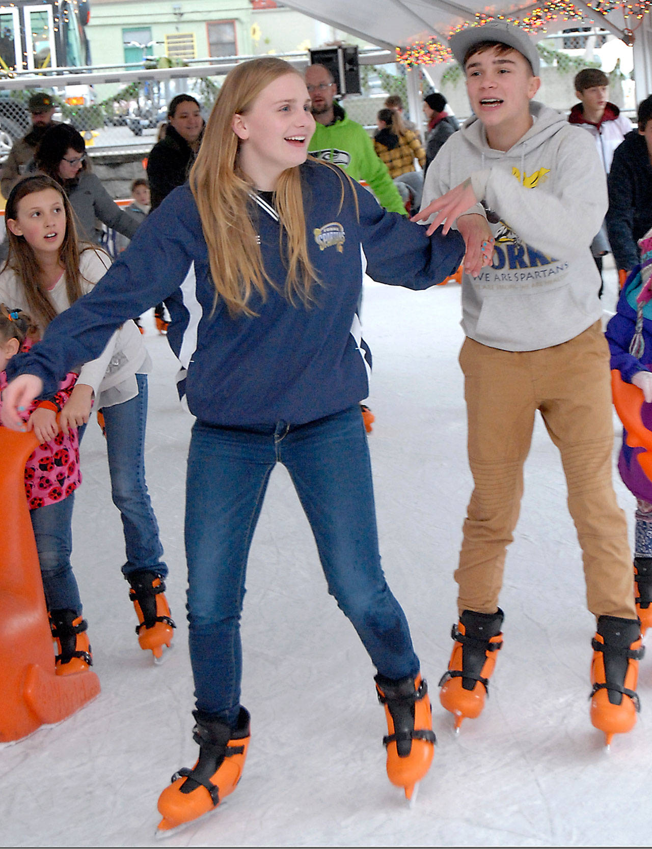 &lt;strong&gt;Keith Thorpe&lt;/strong&gt;/Peninsula Daily News                                 Kadie Wood, left, and Grady Earls, both 13 of Forks, enjoy an afternoon skating Saturday at the Port Angeles Winter Ice Village in downtown Port Angeles.