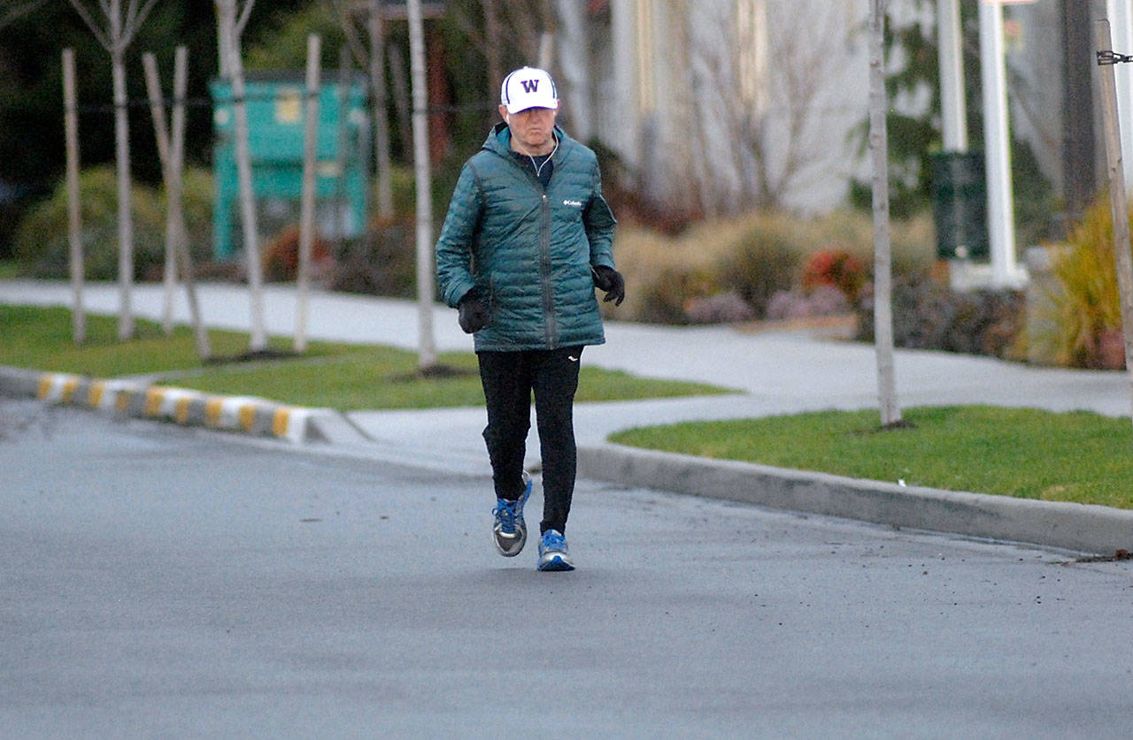 Bruce Skinner jogs down Georgiana Street in Port Angeles on Saturday at the end of a 20-mile practice run. (Keith Thorpe/Peninsula Daily News)