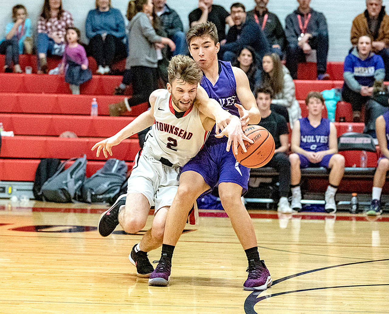 Port Townsend’s Jaden Watkins, 2, steals the ball away from Sequim’s Michael Young during a Crush in the Slush game played in Port Townsend on Saturday. (Steve Mullensky/for Peninsula Daily News)