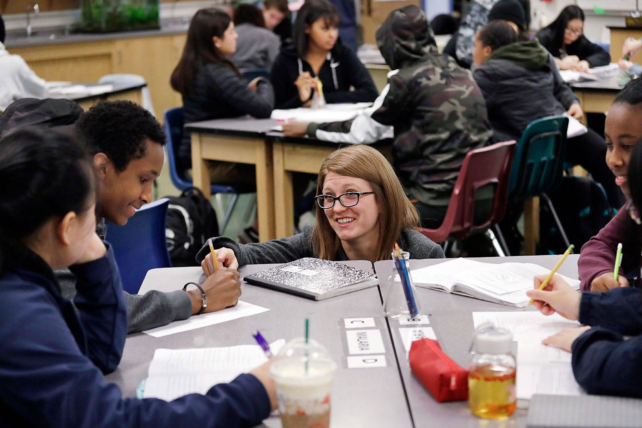 Teacher AJ Katzaroff, center, talks with sophomores in her first period biology class at Franklin High School in Seattle. (Elaine Thompson/The Associated Press)