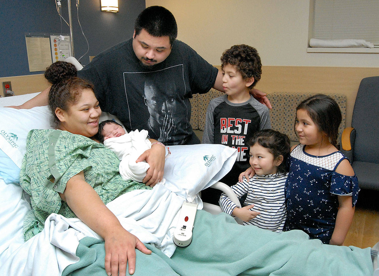 Chelsea Dailey of Port Angeles holds her newborn son, Euriah Sea Della, who was born around 8 a.m. Wednesday, making him the first baby born in Clallam County for 2019, as father, Elijah Della, and siblings Shawn Clark Jr., 8, Aliyah Della, 3, and Nevaeh Della, 4, look on. Euriah entered the world at 8 pounds, 13 ounces and was 20½ inches long. (Keith Thorpe/Peninsula Daily News)