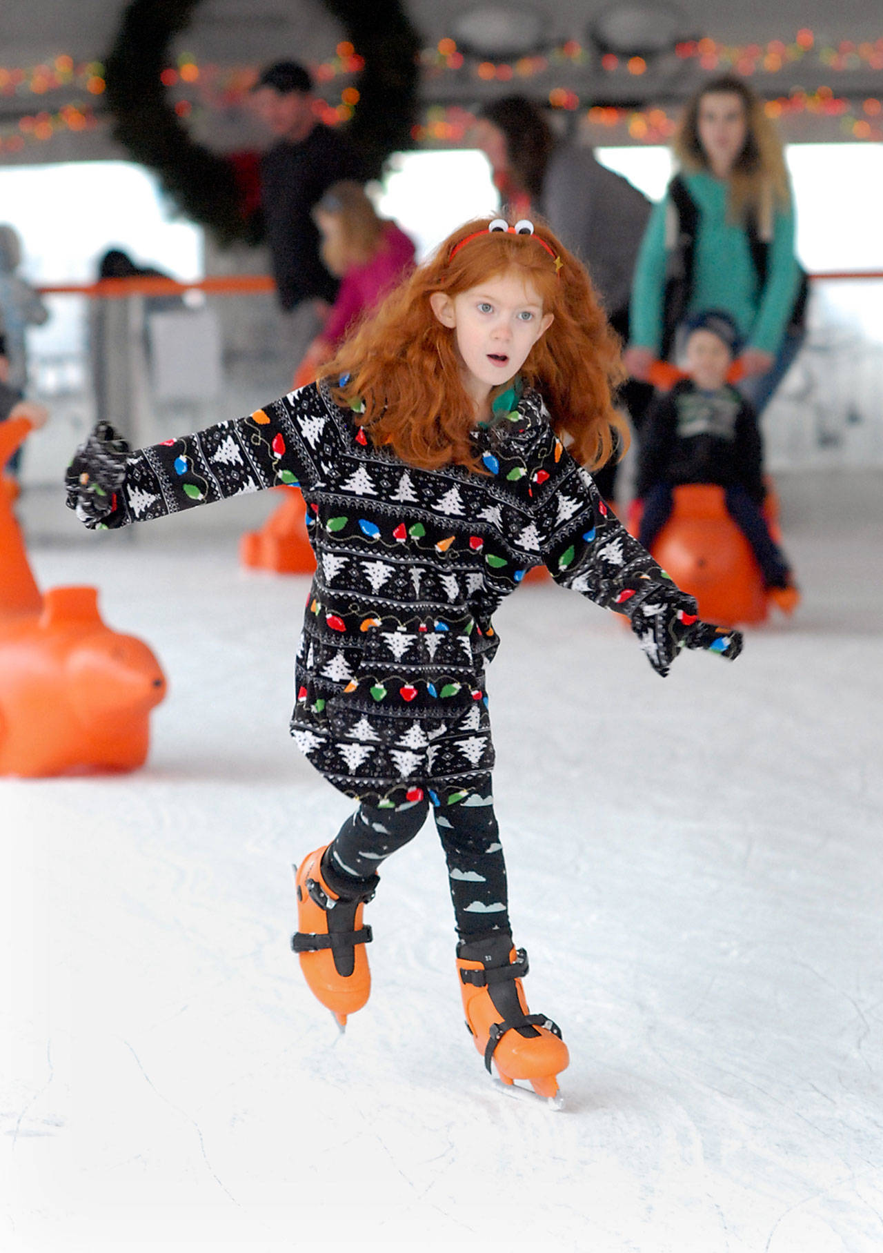 Seven-year-old Alana Emerton of Port Angeles shows grim determination to stay upright as she skates at the Port Angeles Winter Ice Village on Saturday. (Keith Thorpe/Peninsula Daily News)