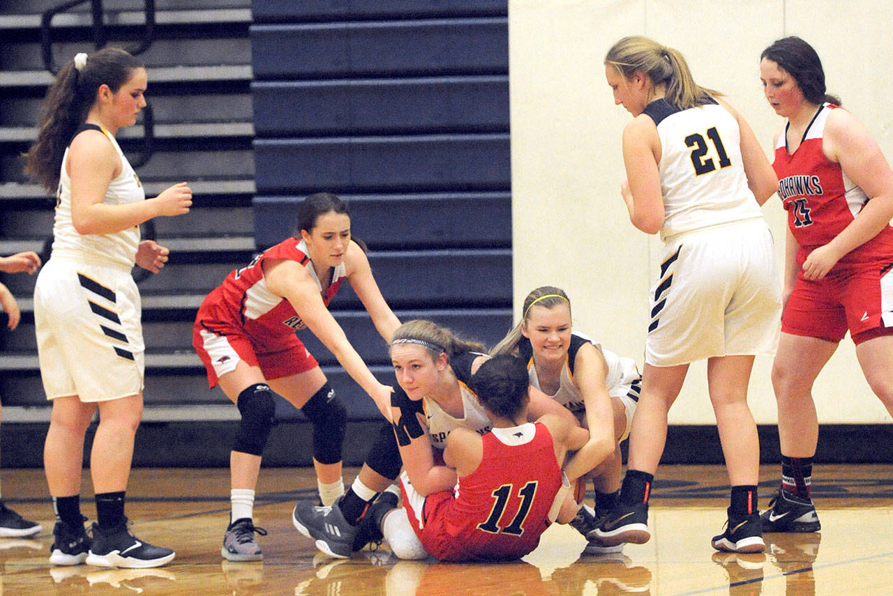 On the floor, Spartan Elliahna Kilmer (left) and Spartan Jayden Olson compete for ball control with Redhawk Gina Brown Friday night in Forks during this non league contest. Also in on the action from left are Spartan Rian Peters, Redhawk Sorina Johnston, Forks Chloe Leverington and Redhawk Katie Ballard. Lonnie.